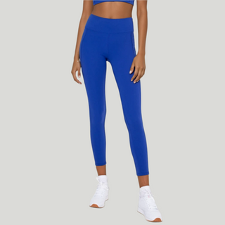 Woman wearing a blue athletic outfit on a white background