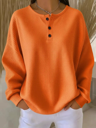 Woman wearing waffle knit button-detail top