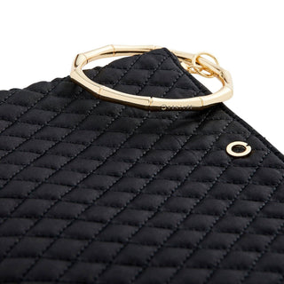 Close-up of black diamond quilting and the segmented gold bracelet handle