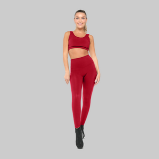 Woman wearing a red athletic outfit on a white background