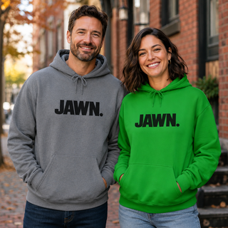 Man and woman wearing gray and green JAWN. Philly unisex hoodies outdoors