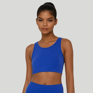 Woman wearing a blue athletic outfit on a white background