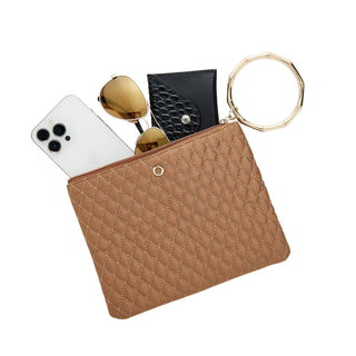 Caramel quilted Big O bracelet pouch filled with a phone, wallet, and sunglasses