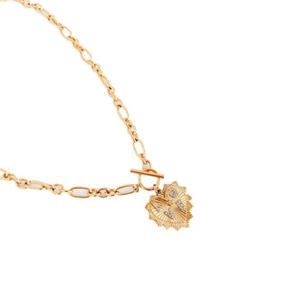 Gold bracelet with a heart-shaped clasp on a white background