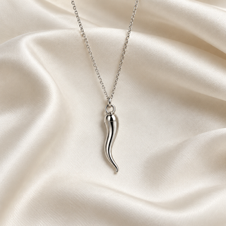 Silver-tone Italian horn pendant necklace on ivory fabric
