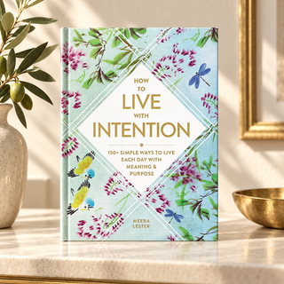 How to Live with Intention by Meera Lester displayed in a warm sunlit setting