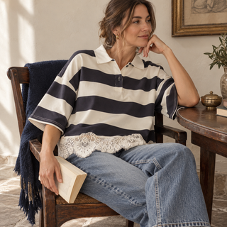 Lace-trim striped polo pullover styled with relaxed denim in a seated lifestyle view
