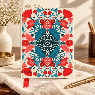 Nina Pace True Blue foiled journal displayed on a warm writing desk