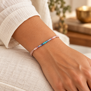 Woman wearing the delicate Om Namaste pink cord and multicolor stone bracelet