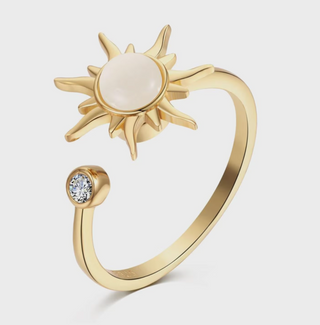 Gold Solstice Spinner Ring with pearl-look sun center and crystal accent