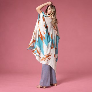 Woman modeling the white, coral and turquoise Sweeping Floral Kimono