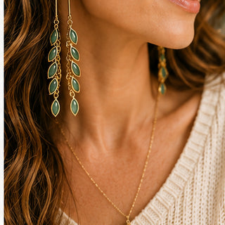 Woman wearing Verdant Cascade green leaf tassel earrings