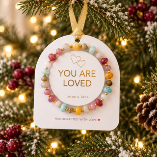 You Are Loved ornament bracelet displayed on a Christmas tree